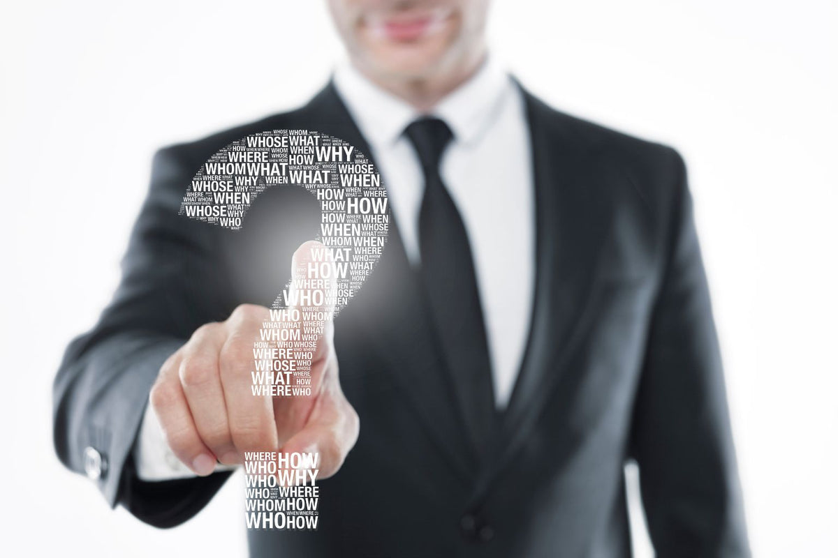 Businessperson pointing to a question mark, illustrating how to choose a medical device sourcing agent in China